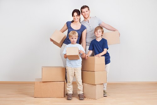 Packed office boxes and furniture ready for a business move in Catford