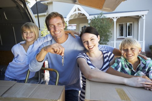 Professional movers handling household items in Catford