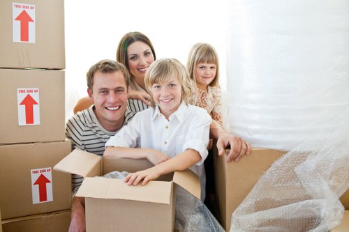 Furniture being carried from a flat in Catford by local movers