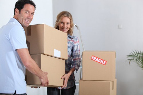 Packed boxes and furniture being loaded into a van